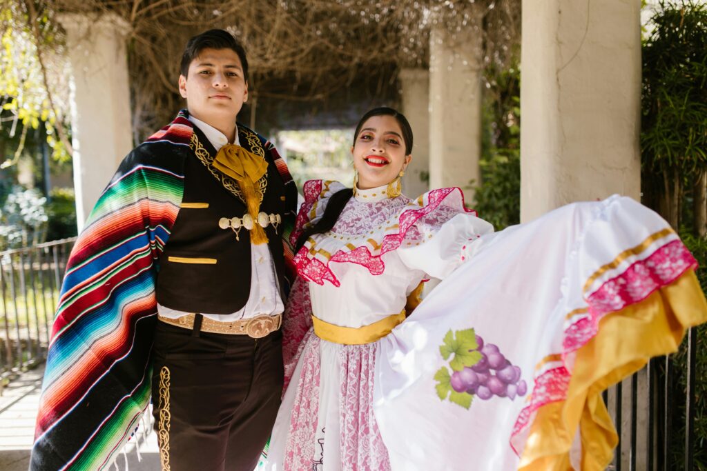 pexels-photo-8638932-8638932 Mexican couple in traditional attire celebrating cultural heritage outdoors.