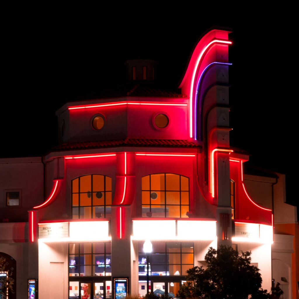 pexels-photo-18440206-18440206 Vibrant neon lights illuminate a cinema building in Atascadero, CA at night.